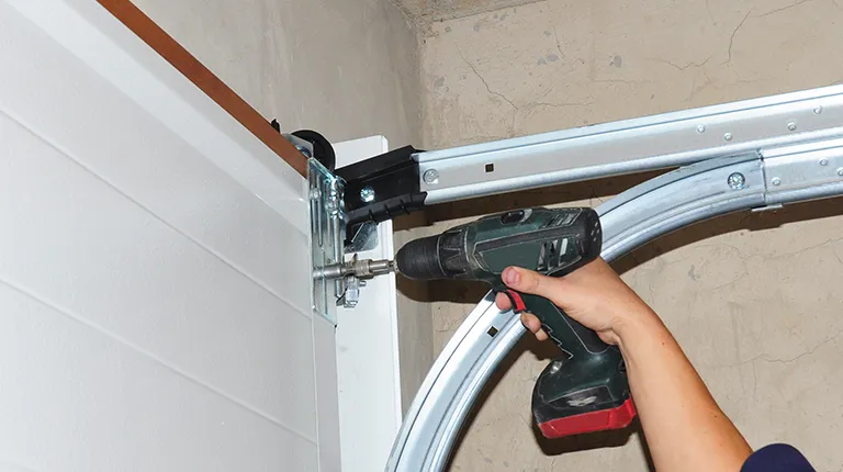 Worker repairing garage door